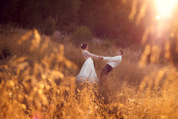 Happy married couple. Outdoors photos in golden hour, afternoon, warm light