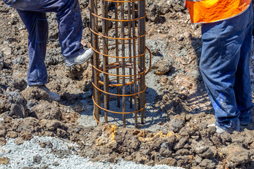 Workers pour concrete for pile foundation