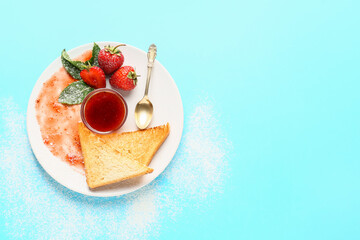 Plate with tasty strawberry jam and bread on color background