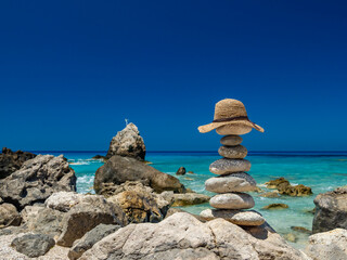 Straw Sunhat at the beach on stones
