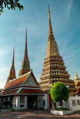 Naklejka premium Beautiful colorful temple in bangkok with bonsai, sunlight, Wat Pho