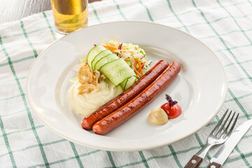 grilled sausage served with beer, mashed potato, vegetable salad for Octoberfest on the table