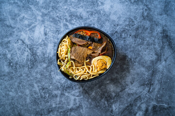 Shoyu Ramen Noodle with Egg, Soy Sprouts, Veal Meat, Carrot, Onion, Seaweed Wakame, Japanese Radish and Soy Sauce.