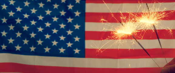 American flag on background of fireworks. Patriotic holiday background. The USA are celebrating 4th...