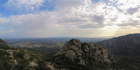 Panoramic view of a ruined castle on top of a mountain at sunrise