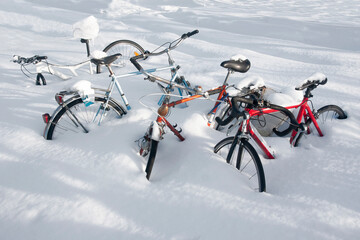 bikes in snowdrift after heavy snowstorm