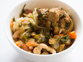 Chicken noodles in a white bowl. Home traditional cuisine