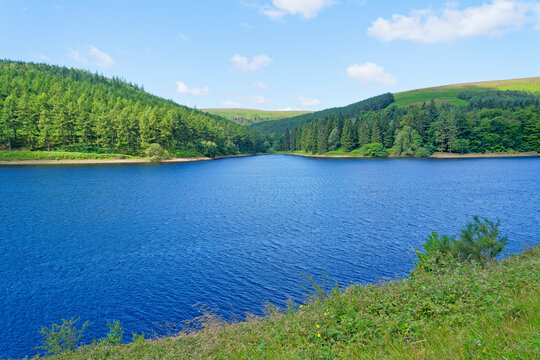 Standing high above Derwent Reservoir on a hzy day looking across the rippled water