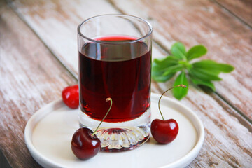 red cherry drink in glass and cherry fruit