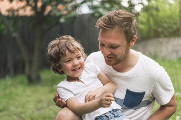 Father and his son playing and hugging in outdoors. Concept of Father's day. 