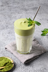 Dalgona Iced Matcha tea. Whipped white eggs with matcha tea is added to milk with ice.