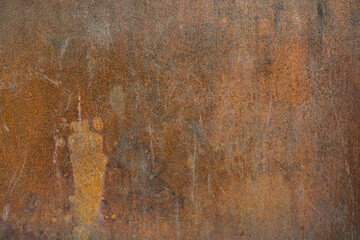 Old rusty metal surface with black paint flaking and cracking texture