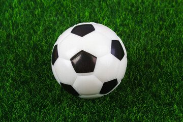 Traditional soccer ball on soccer field. Football ball on green grass stadium football field, game, sport. Background for design.