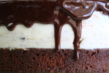 chocolate drip on cake closeup. mousse caramel cake with caramel topping and grated chocolate closeup. dessert isolated on black