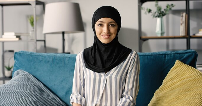 Portrait Of Beautiful Happy Arabic Emirati Lady In Hijab At Home.
