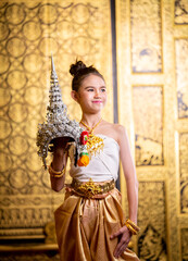 Fototapeta na wymiar Thai traditional dress. Young kid Actors performs Thai ancient dancing Art of Thai classical dance in Thailand