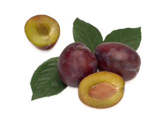 Three plums with plum leaves on a white background.