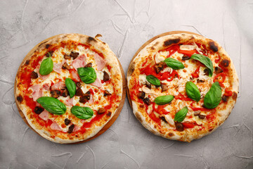 set of two pizza on light concrete or stone table top view. pizza with mushrooms and chicken or hum