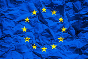 Flag of the European Union on crumpled paper. Flag printed on a sheet. Flag image for design on flyers, advertising.