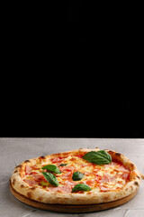 pizza with ham and cheese closeup on light concrete or stone table