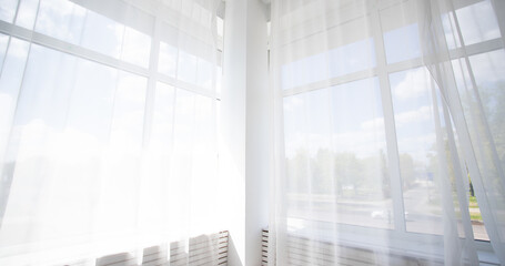 Bright room interior, curtains, white window sill, panoramic view from the window