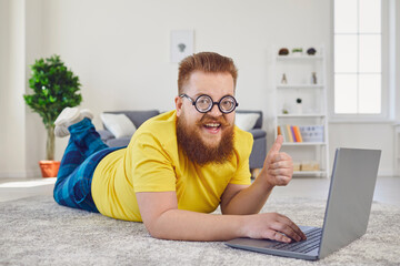 Work online at home office. Funny man works online communicates video chat call using laptop lying...