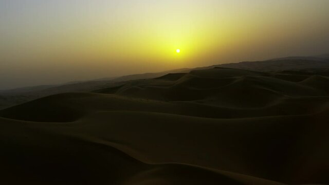 A picture-perfect of the sunset on the desert with the magnificent twilight on the horizon, capturing a stunning curve of the sand dunes.6-axis stabilized gimbal, Shotover F1, 8K, parallax.