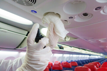 Close up hand is wearing gloves cleaning aircraft for covid-19 prevention pandemic