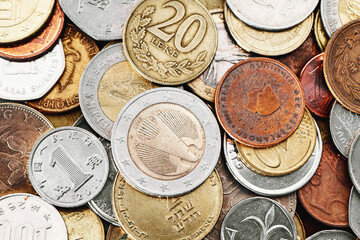 Different currency coins stacked. Pile of money. Metal coins texture. Financial world background....