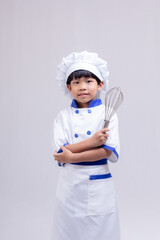 boy in chef uniform on white background