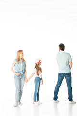 Fototapeta premium full length view of mother and daughter looking at man isolated on white