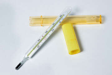 the thermometer lies on a white background. Thermometer for measuring human temperature