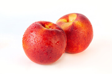Peach or nectarine and peach slice with leaf on white background