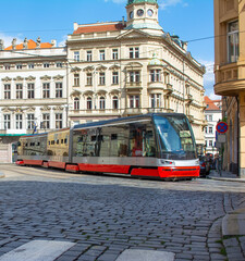 Naklejka na ściany i meble New tram in the city on the bridge.