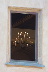 The royal chandelier is visible through an open window
