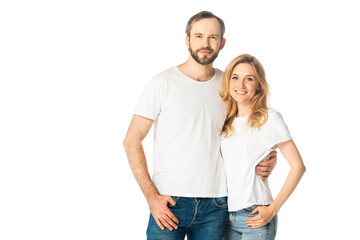 cheerful adult couple in white t-shirts embracing isolated on white