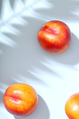 Peach or nectarine and peach slice with leaf on white background