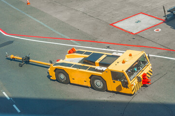 Tow truck vehicles trailer for puch back plane at the airfield. © aapsky