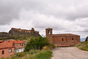 Parish church of La Asuncion and in the background the castle of Clavijo, in ruins, construction...