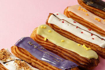 Fresh eclair cakes on pink background close up