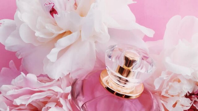 Pink perfume bottle with peony flowers, chic fragrance scent as luxury cosmetic, fashion and beauty product backgrounds