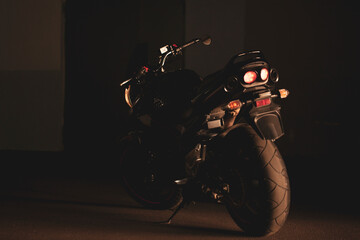 Naklejka premium Black motorcycle on the background of underground parking.