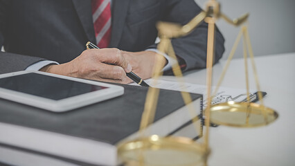 Judge gavel with Justice lawyers having team meeting at law firm background. Concepts of Law and...