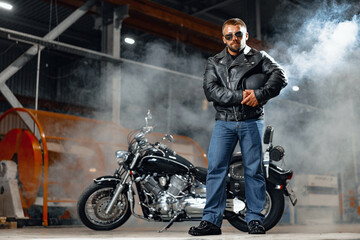 Obraz na płótnie Canvas Portrait of motorbike rider in black leather outfit