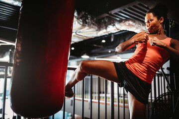 Young fit woman boxing workout in gym