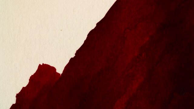 Red color paints over the white paper, stop motion shot