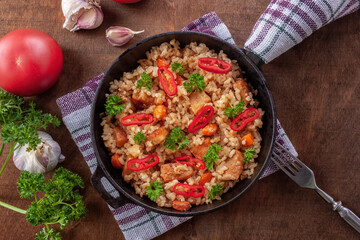 Rice with meat, vegetables and parsley in a serving pan