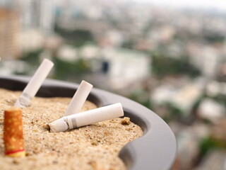 The rest of cigarettes in the ashtray. A cigarette is not good for health and environment. It is not allow to smoking in the public area in Thailand. Cigarette smoke is air pollution.