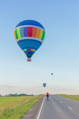 Hot air balloons over the countryside road in summer