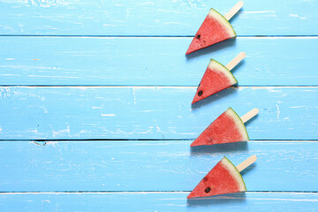 4 Sliced watermelon fruit on the old blue wooden table for background with copy space.